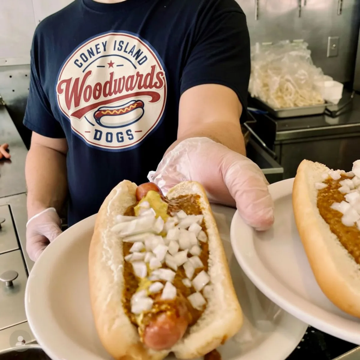 Woodwards serving fresh hot dogs under the tent at a backyard party
